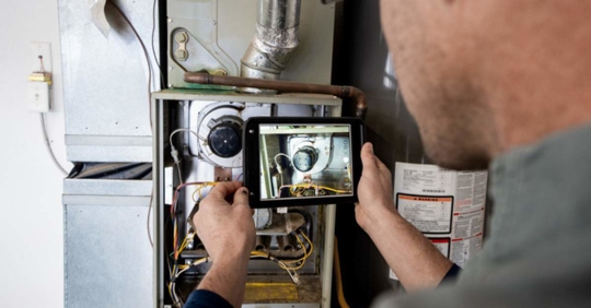 HVAC technician performing a furnace inspection