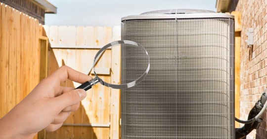 person inspecting an HVAC unit